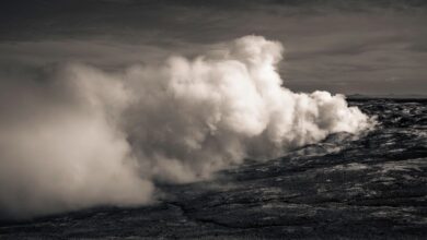 Geothermal power plant with steam rising from vents against a clear sky