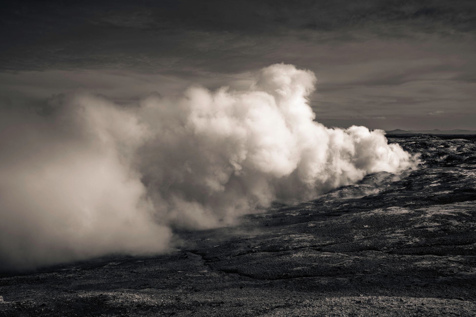 Geothermal power plant with steam rising from vents against a clear sky