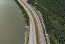 Aerial view of a multi-lane toll highway stretching through open landscape