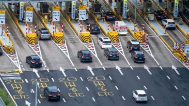 Aerial view of a multi-lane toll road with traffic flowing through payment booths