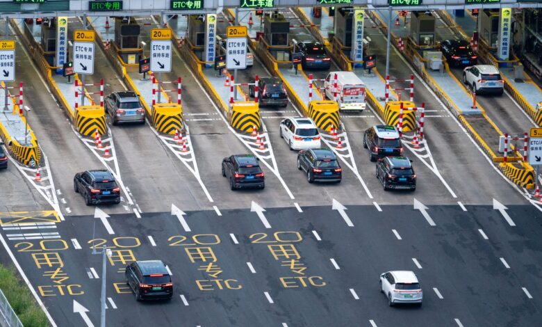 Aerial view of a multi-lane toll road with traffic flowing through payment booths