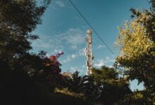 Cell tower against blue sky representing wireless infrastructure easement investments