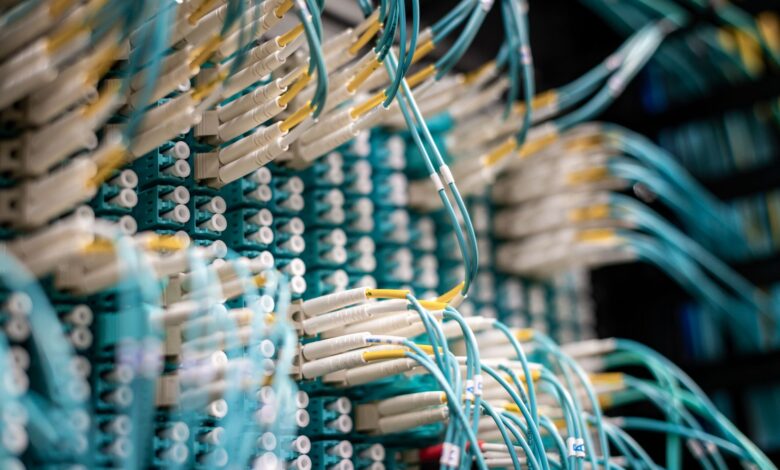 Underground fiber optic conduit cables laid in a trench beneath a road