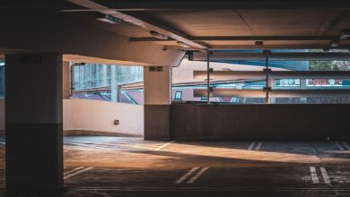 Multi-level urban parking garage structure with cars on several floors
