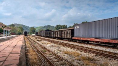 Aerial view of a freight rail terminal with intermodal containers and rail lines