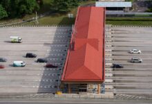 Aerial view of a multi-lane toll road cutting through open landscape