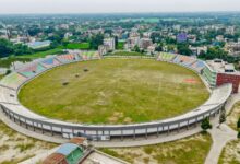 Aerial view of a large sports stadium surrounded by urban infrastructure