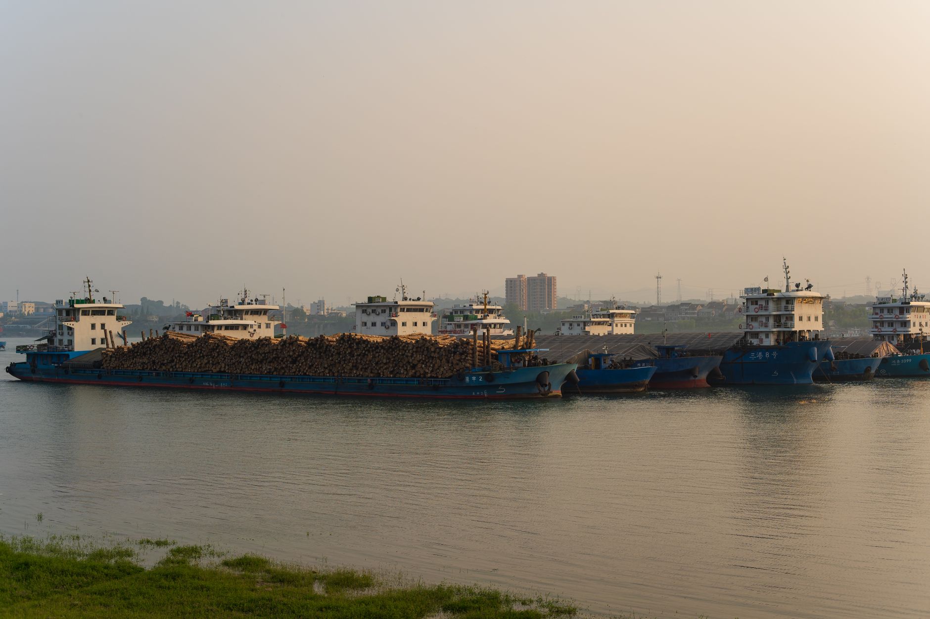 Aerial view of an inland freshwater port with docked cargo vessels along a river