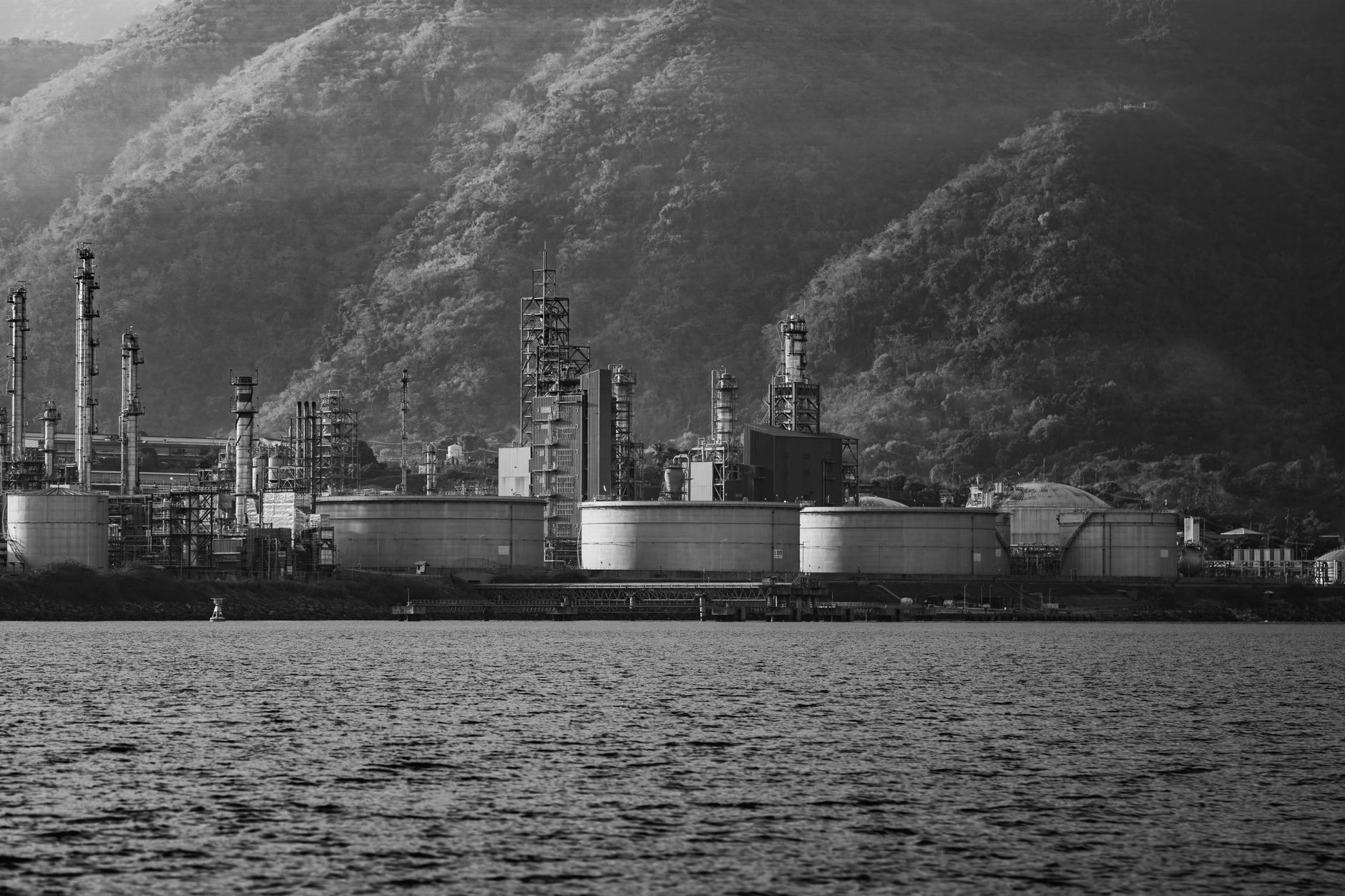 Large industrial storage tanks at a petroleum refinery facility