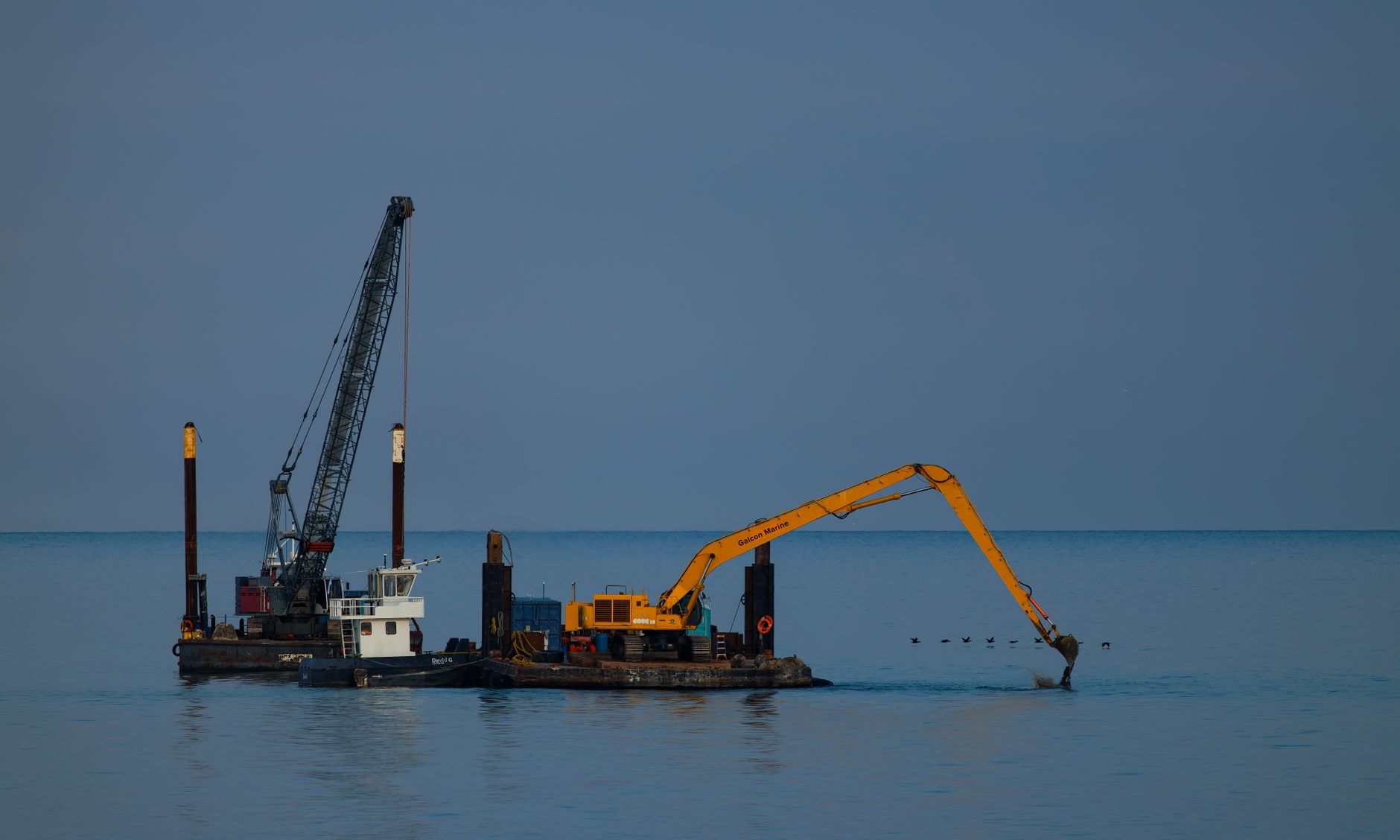 Industrial dredging equipment operating in a commercial waterway channel