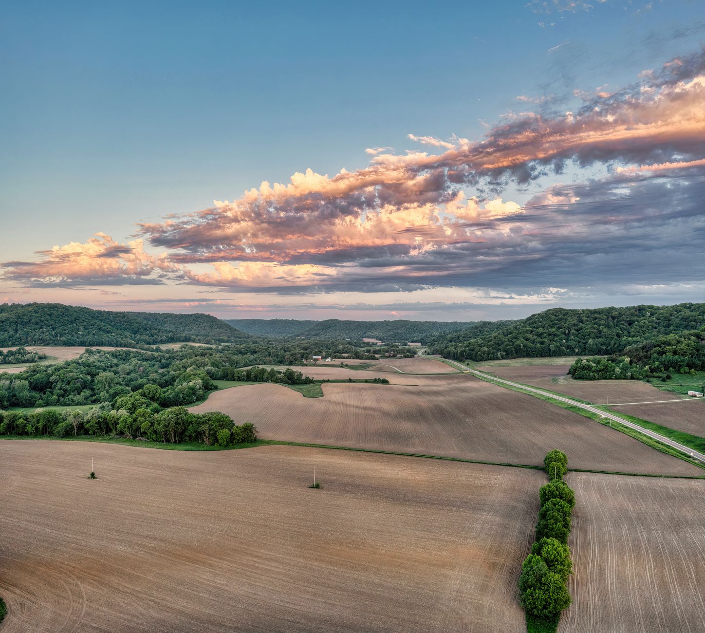Open agricultural land under a wide blue sky, typical of solar farm lease sites