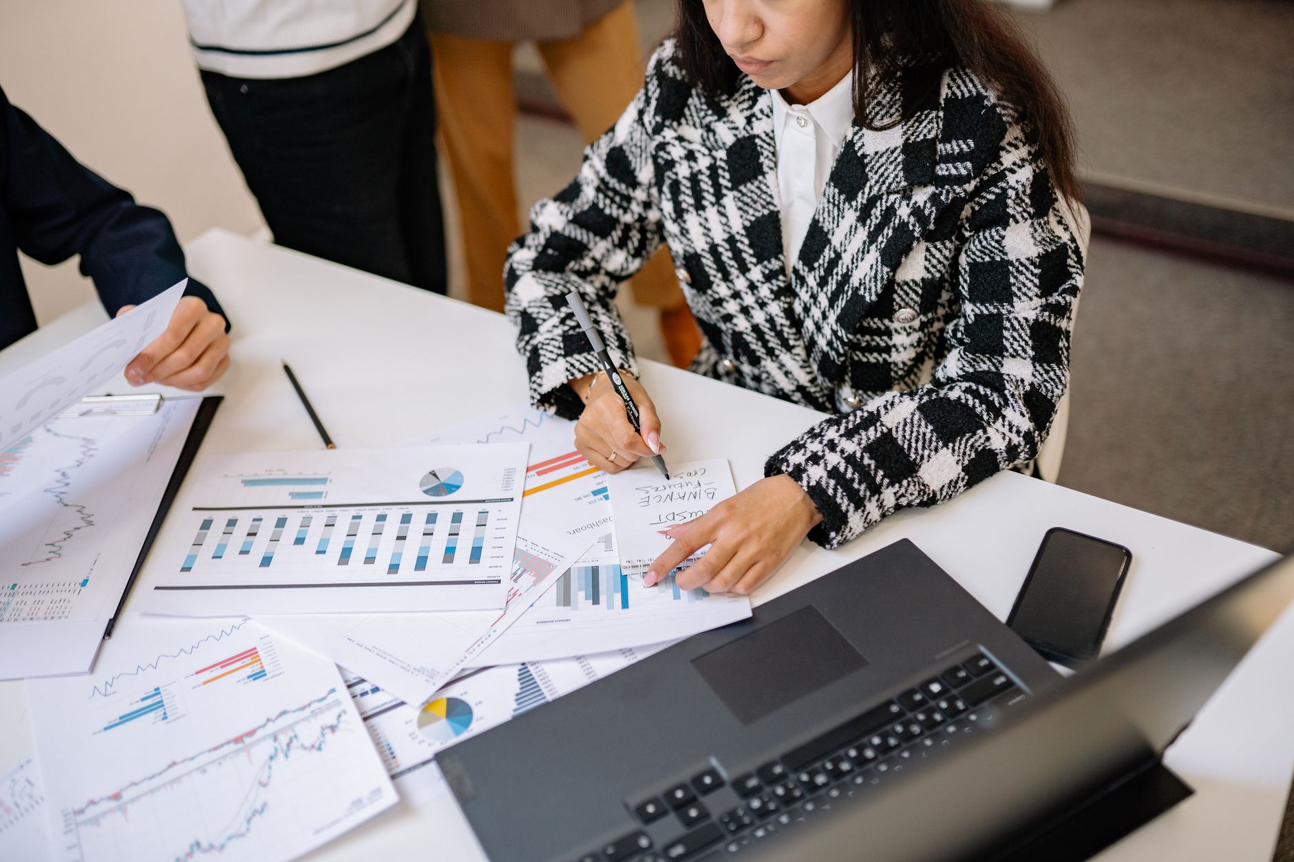 Institutional investors reviewing infrastructure investment documents at a conference table