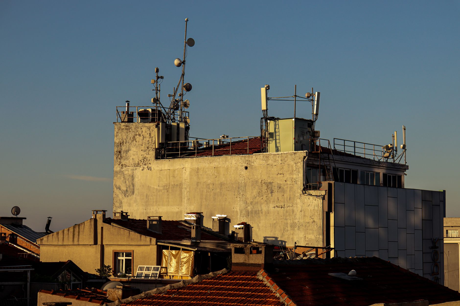 Urban cellular antenna mounted on a building rooftop representing broadband spectrum assets in dense metro markets
