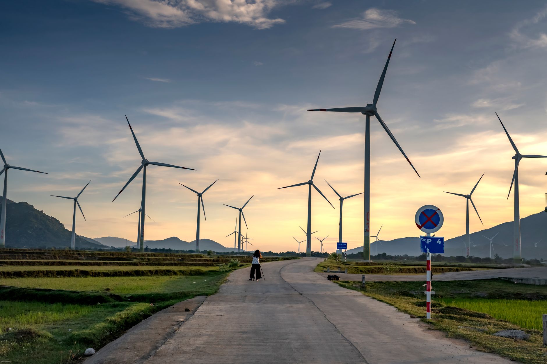 Wind turbines standing in an open field generating clean energy