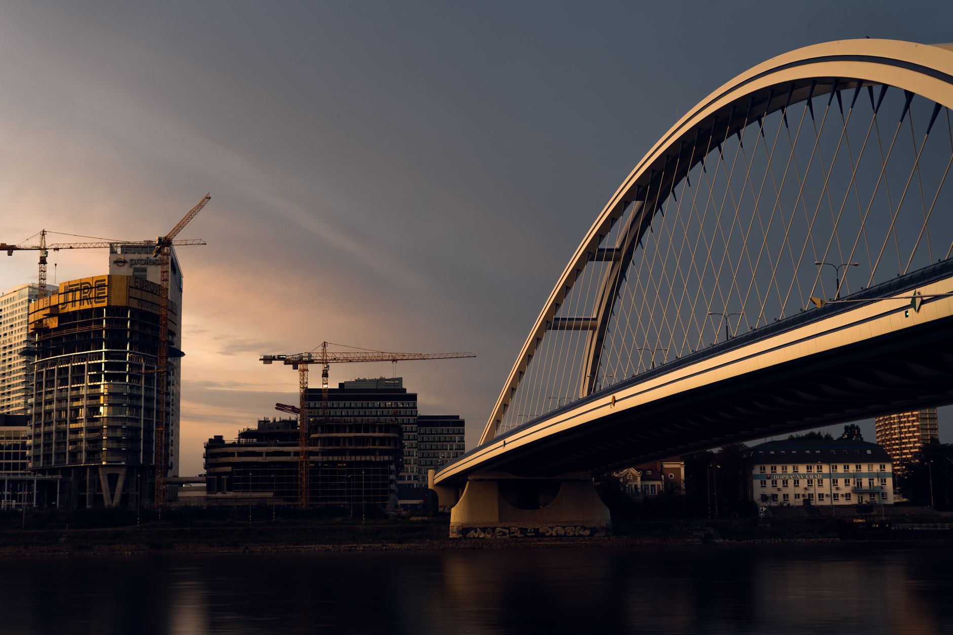 Large-scale road infrastructure project under construction with cranes and support structures