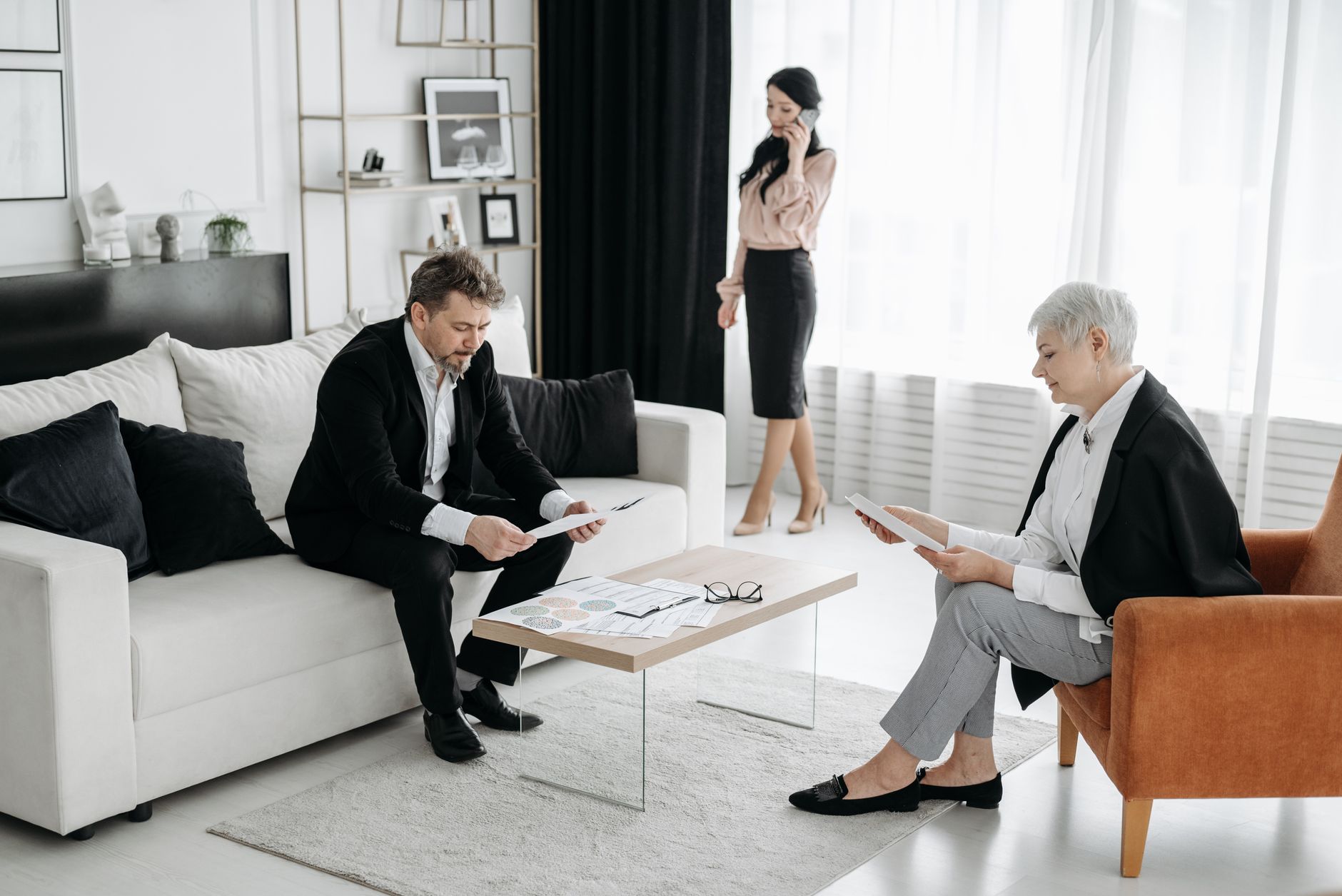 Investment professionals reviewing documents in a private office setting