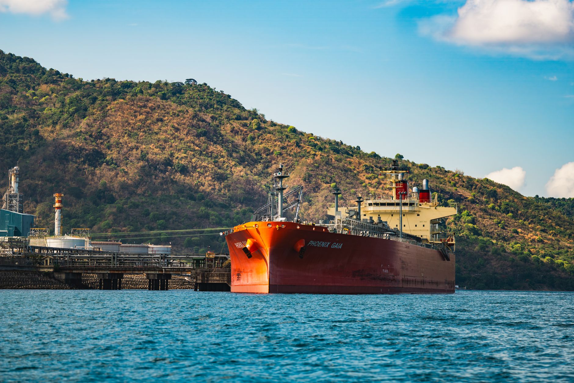 Large cargo vessels docked at a commercial shipping terminal