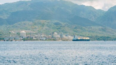 Large liquefied natural gas terminal with storage tanks and docking infrastructure along a waterway