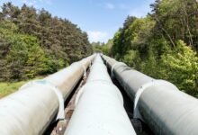 Underground carbon pipeline infrastructure running through flat agricultural land