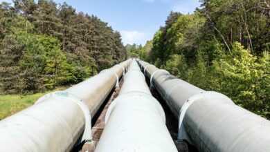Underground carbon pipeline infrastructure running through flat agricultural land