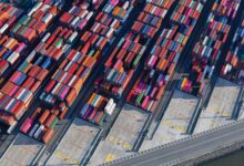 Aerial view of a large freight terminal with shipping containers and cargo infrastructure