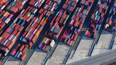 Aerial view of a large freight terminal with shipping containers and cargo infrastructure