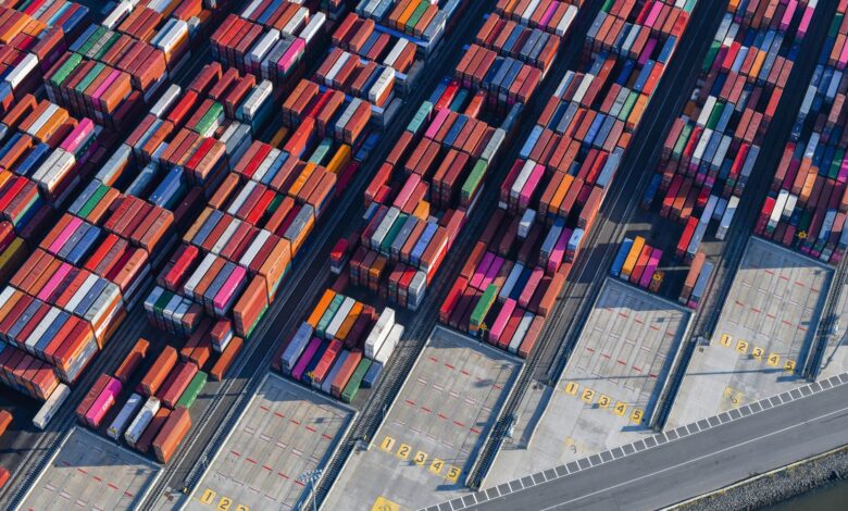 Aerial view of a large freight terminal with shipping containers and cargo infrastructure