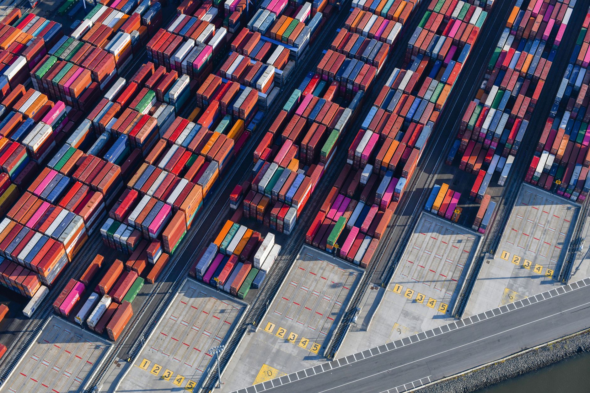 Aerial view of a large freight terminal with shipping containers and cargo infrastructure