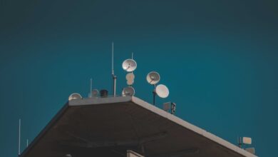 Large satellite dish arrays at a remote ground station facility pointing toward the sky