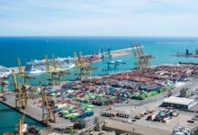 Aerial view of a large commercial cargo port with container ships and shipping channels