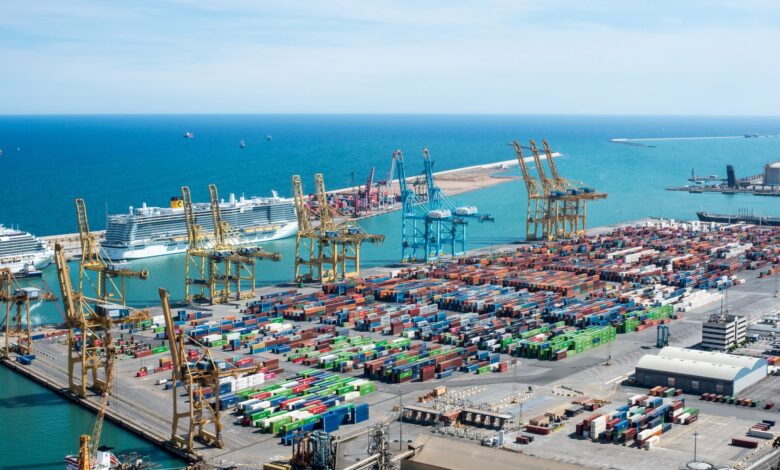 Aerial view of a large commercial cargo port with container ships and shipping channels