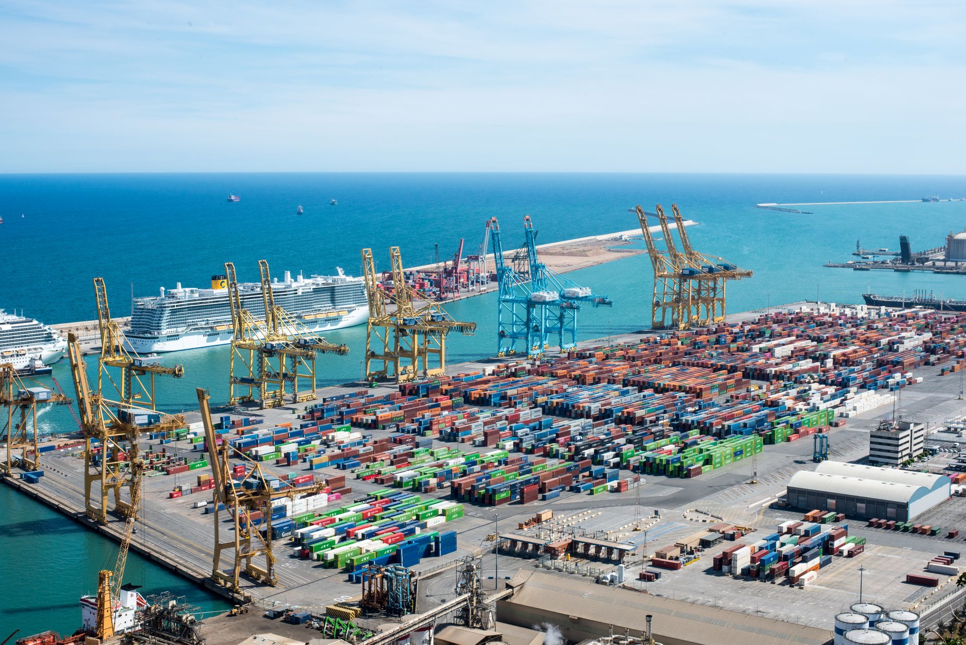 Aerial view of a large commercial cargo port with container ships and shipping channels