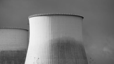 Aerial view of a nuclear facility with cooling towers and surrounding landscape