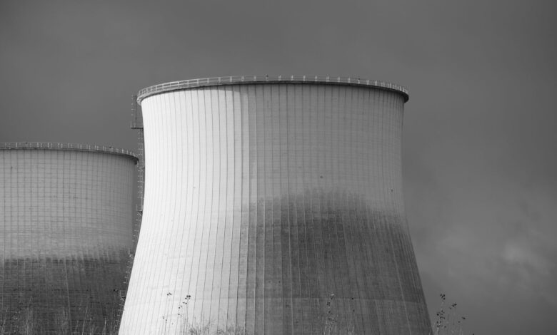 Aerial view of a nuclear facility with cooling towers and surrounding landscape