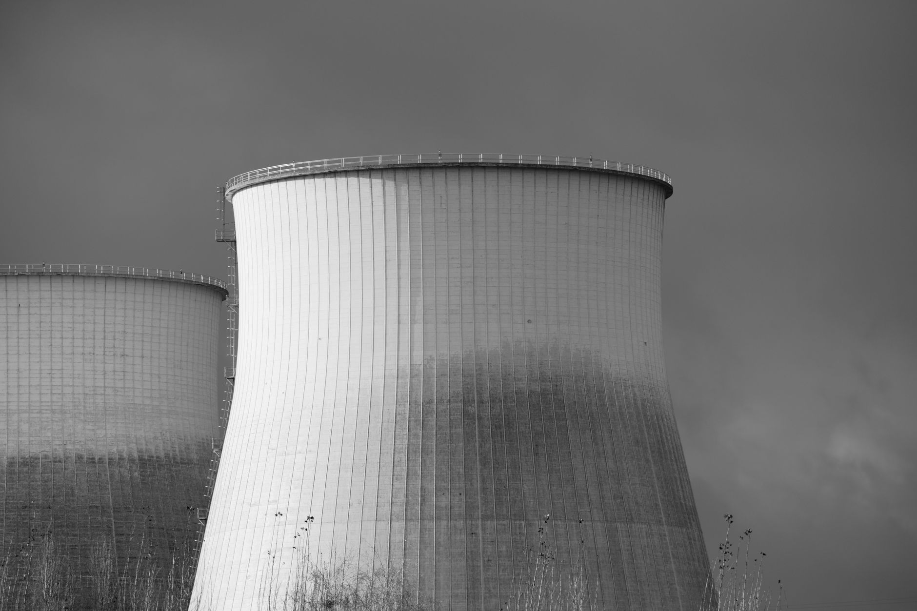 Aerial view of a nuclear facility with cooling towers and surrounding landscape
