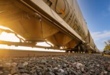 A freight train moving through a rural rail corridor representing easement land rights