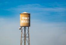 A municipal water tower rising above a residential neighborhood