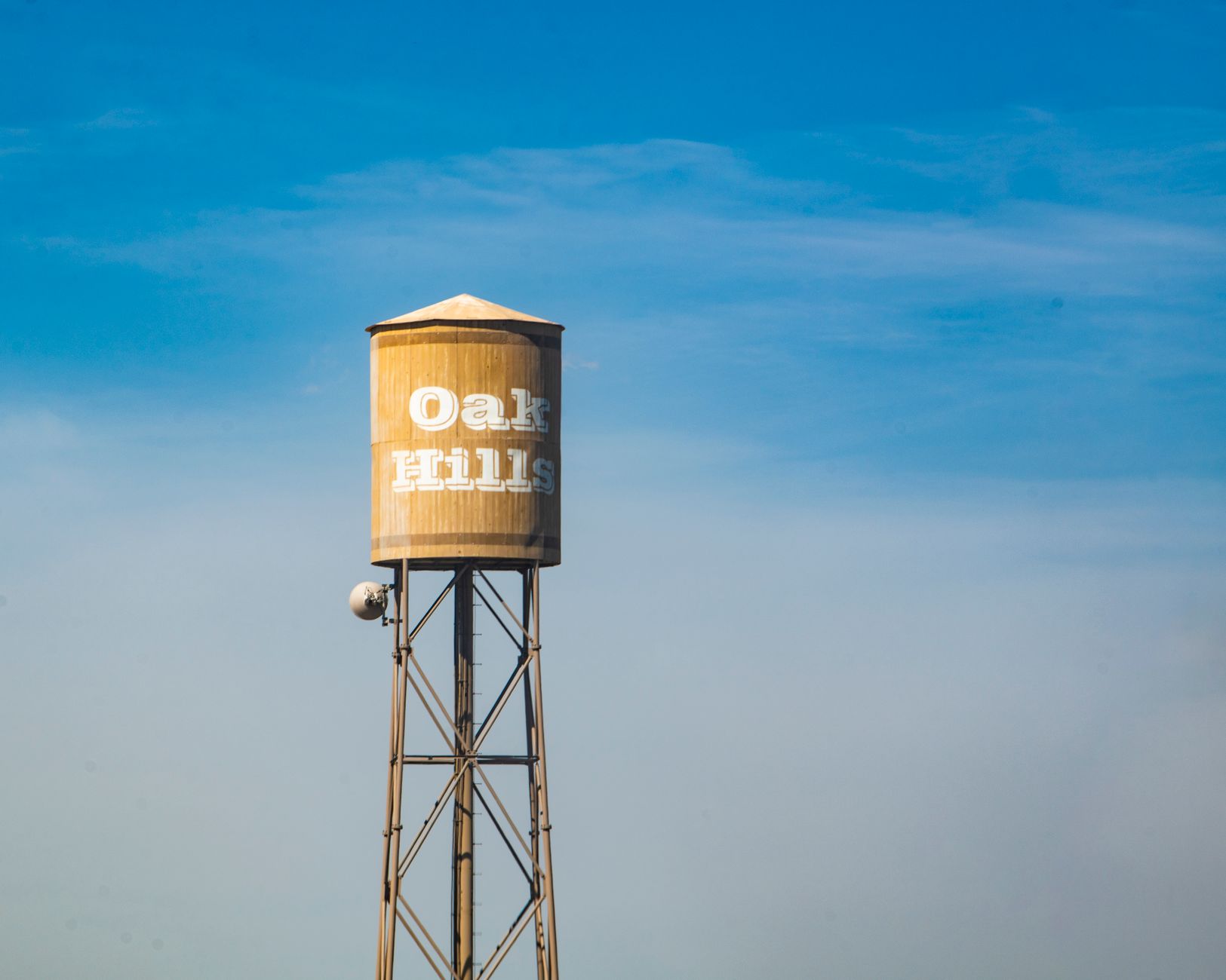 A municipal water tower rising above a residential neighborhood