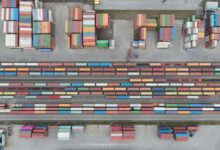 Aerial view of a large rail yard with freight trains and industrial infrastructure