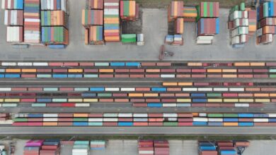 Aerial view of a large rail yard with freight trains and industrial infrastructure