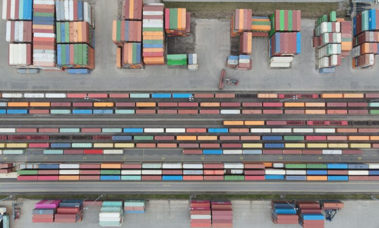 Aerial view of a large rail yard with freight trains and industrial infrastructure
