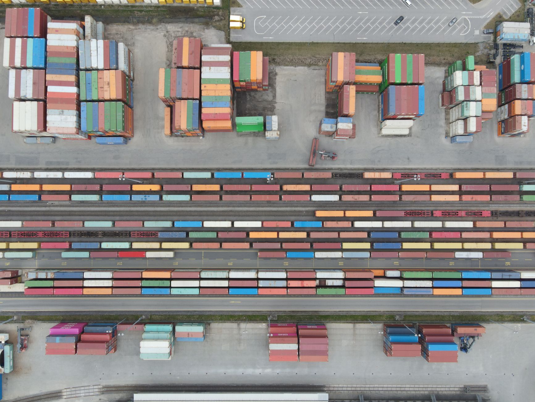Aerial view of a large rail yard with freight trains and industrial infrastructure