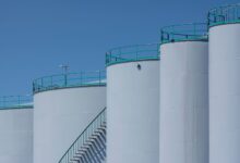 Large crude oil storage tanks at an industrial marine terminal facility