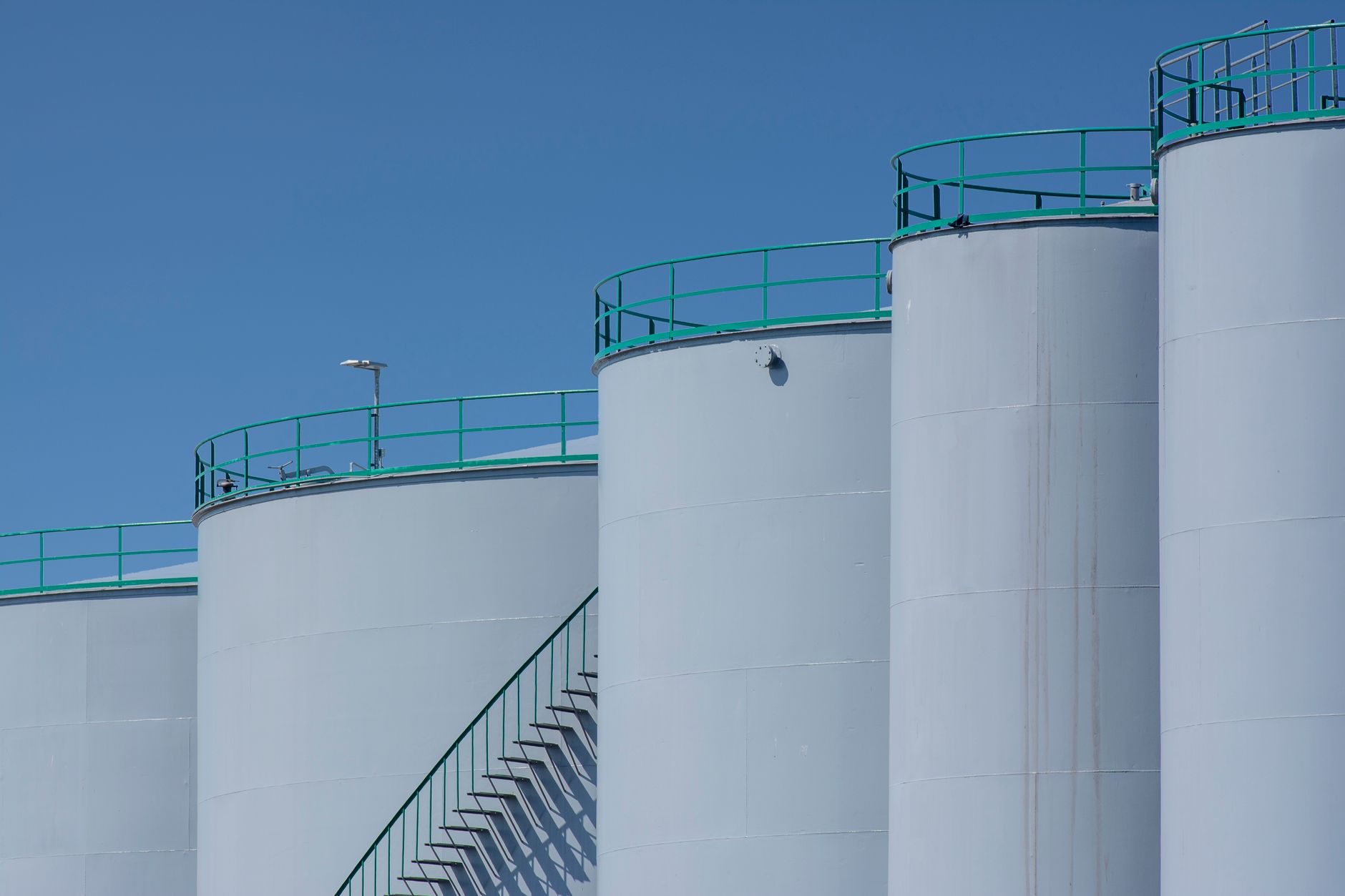 Large crude oil storage tanks at an industrial marine terminal facility