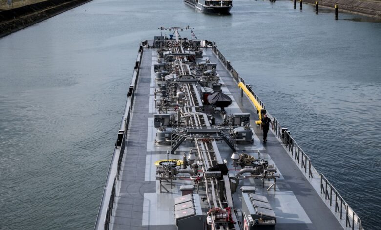 A cargo barge traveling through an industrial freight canal