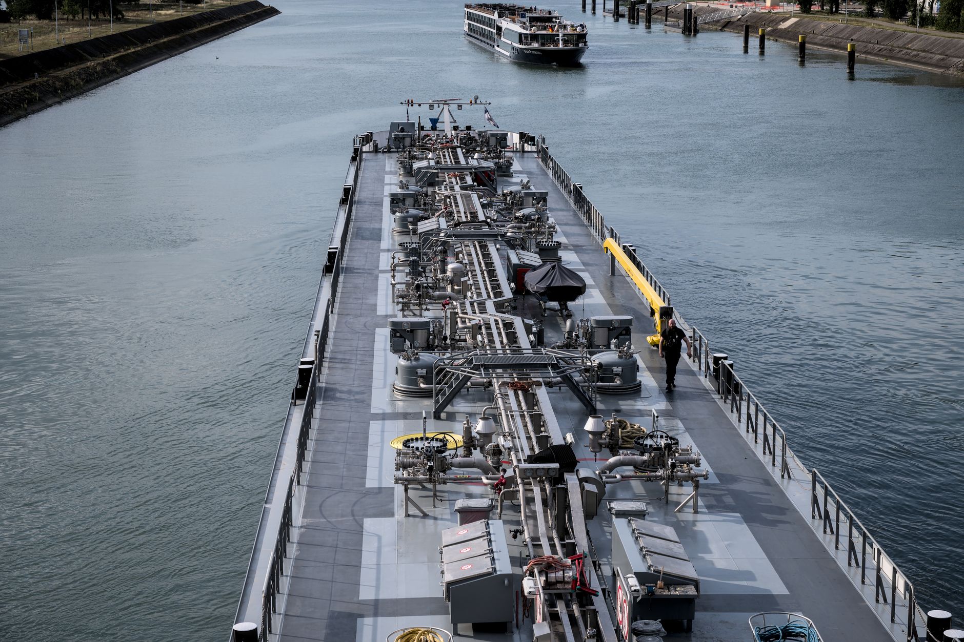 A cargo barge traveling through an industrial freight canal