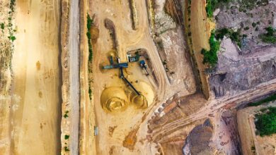 Aerial view of an active quarry operation with water pooling at the base