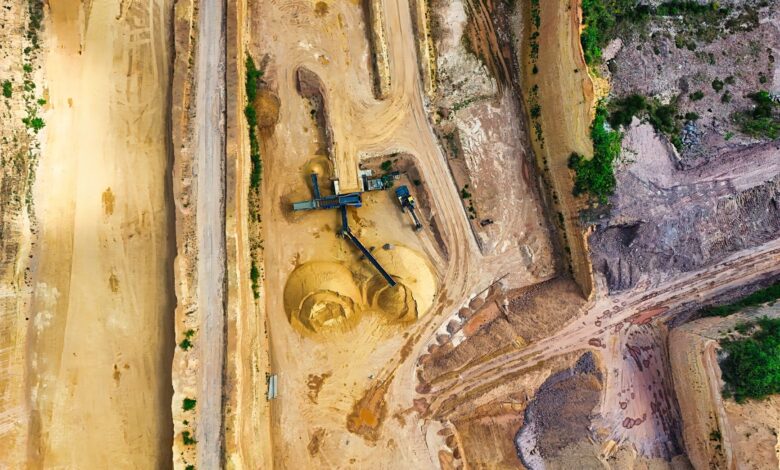 Aerial view of an active quarry operation with water pooling at the base