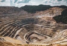 Aerial view of a large potash mining operation with excavation equipment and mineral deposits