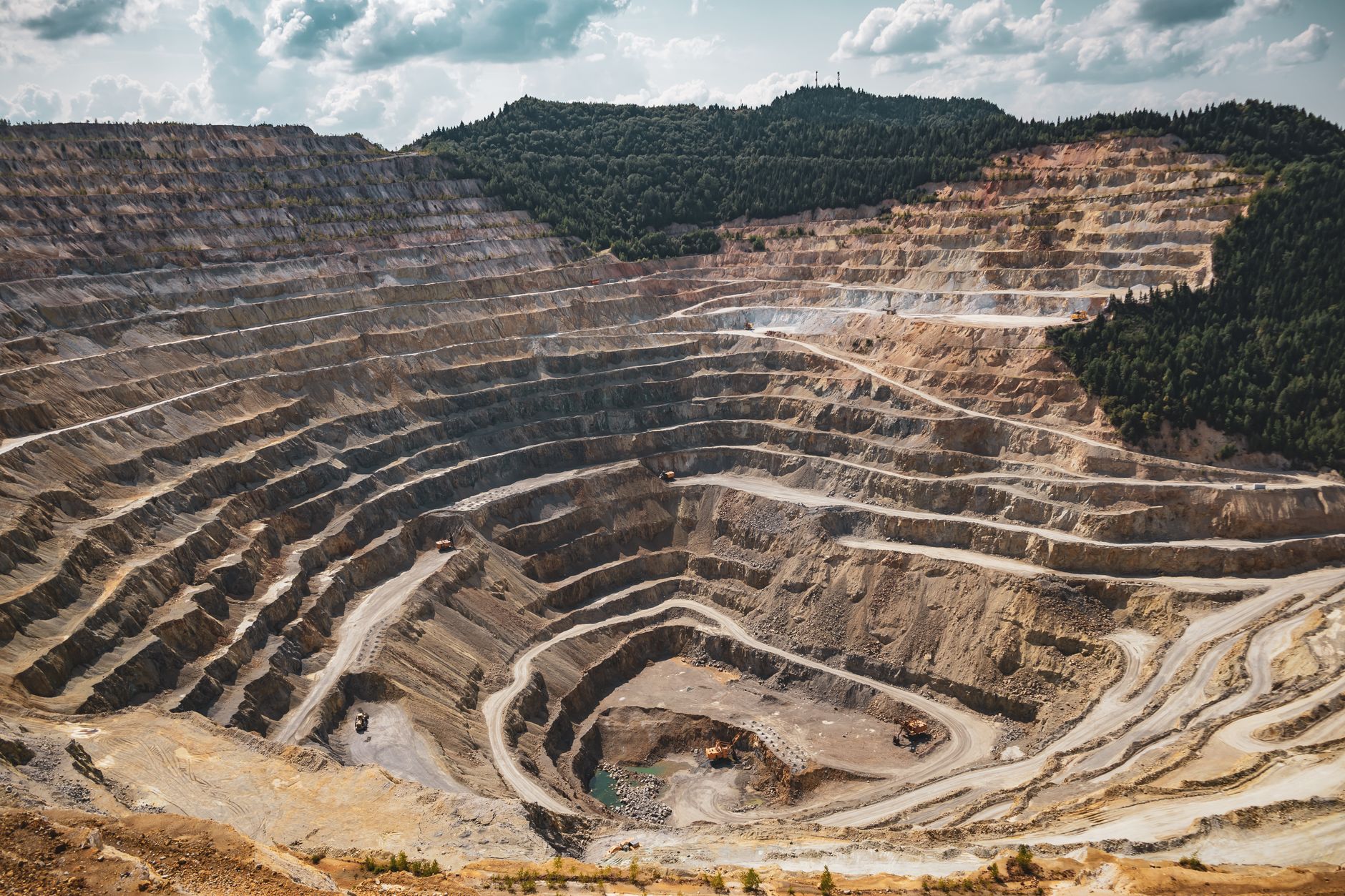 Aerial view of a large potash mining operation with excavation equipment and mineral deposits